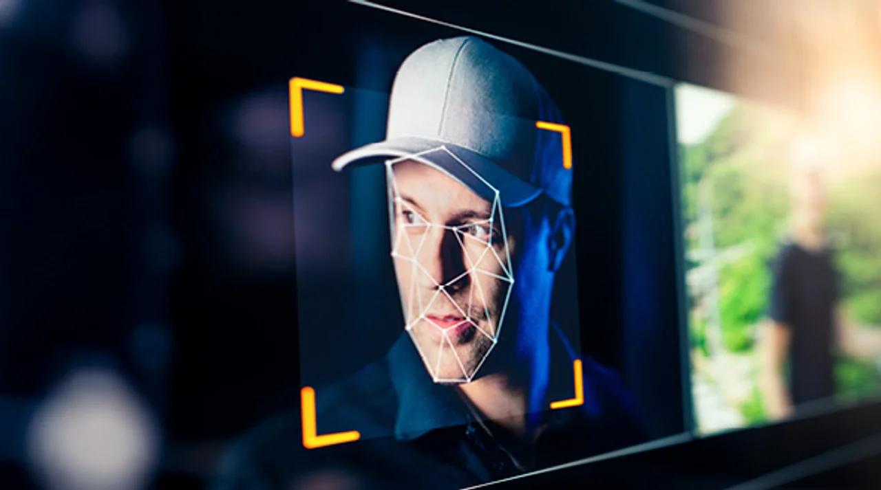 Face of a man wearing a baseball cap being analyzed by facial recognition software