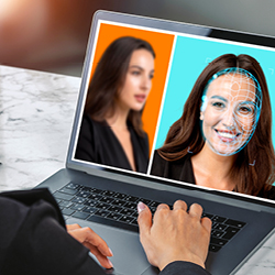 A woman uses facial recognition on a laptop