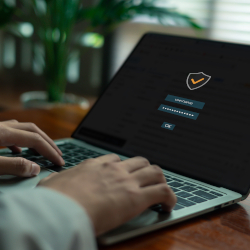 Person typing on a laptop displaying a secure login screen
