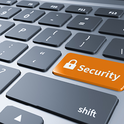 View of a computer keyboard with a blue key featuring a padlock symbol and the word “Security”